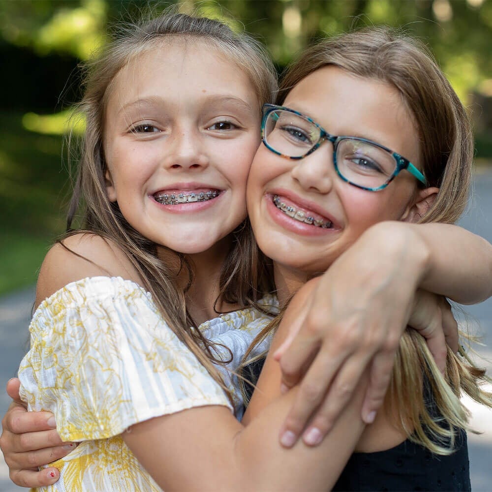 Young girls smiling with braces